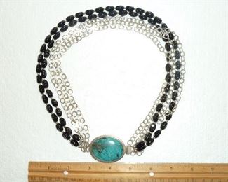 One of a kind Sterling silver and black onyx four strand necklace features textured silver links and a whopping 2" chunky turquoise clasp. It weighs 129 g and is marked SIS and 925 on the back of the clasp. $220
