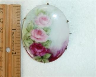 Exquisite 2.5" tall hand painted Victorian porcelain brooch with roses. Brass back with old C clasp. Lovely. $78 