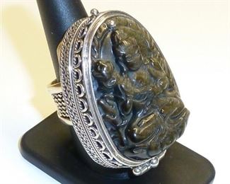 HUGE poison ring. This awesome ring is 2" tall and 1 1/4" wide, and you could hide all sorts of goodies in it :-) Sterling silver, and carved chalcedony. It appears dark chocolate, but has fine sparkles of gold all throughout when in the light. Simply stunning. $600