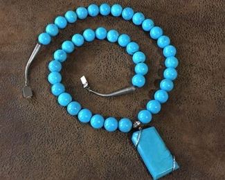 Luscious vintage 27 1/2" L necklace with 13mm turquoise-colored beads & sterling silver wire-wrapped pendant. 2" x 1" pendant. Sterling cones & box clasp.  $120
