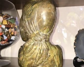 The detail ot the bow the coloring of the browns and greens. With a bright flash you can see the dark green and light green coloring . You can see the details of the carving . The art capture the beauty of the young women. Brown / Green/ Yellow Verdite Created by an Art from Zambia $450