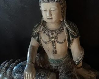 Manjushri is in the "royal ease" position