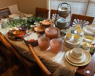 Front room:  Large dining room table with leaf and 8 chairs, seven sets of dishes