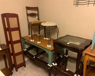 Front Bedroom: Room divider, two coffee tables, four end tables, one desk chair, and a swiveling vanity stool