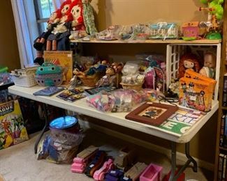 Back bedroom: Raggedy Ann and Andy, Barbie dolls, Lego Friends Sets, LaLa Loopsie, and other dolls.  Wooden cars and trucks on the floor.