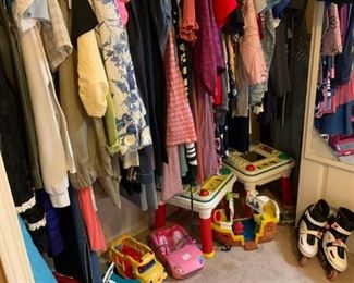 Back bedroom: Women's clothing in Small, Medium, and Large sizes. Some swimwear.  On the floor, Barbie Jeep and RV, Vintage Fisher Price Baby toy, 