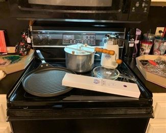 Kitchen: Large griddle pan, New Dalstrong 9" Knife, pop corn popper, Coring Ware Coffee Percolator