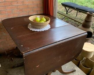 Back Porch: Old wooden dining room table, pottery bowl with fruit.  Not  pictured are some windchimes and other hanging deco items.