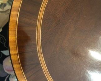 $750 - Banded detail on Council Craftsmen  mahogany, oval dining tabletop. Includes six (6) chairs, two 24" leaves and pads; measures 104" long (with both leaves inserted) and 30" tall.