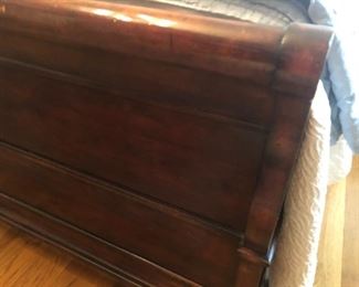 $650 - Close-up view of Henredon mahogany king sleigh bed footboard (does not include mattresses or linens); measures 94" deep, 82" wide, 60" tall.