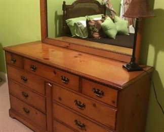 $250 - Pine nine-drawer dresser with matching mirror;  dresser measures 20" deep, 58" wide, 33.5" tall; mirror measures 49" wide, .5"34 tall.
