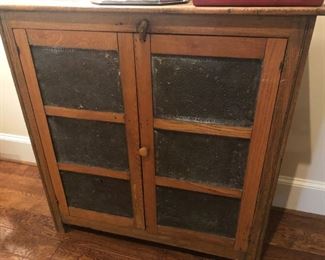 $275 - Antique six-panel, punched-tin pine pie safe; measures 16.75" deep, 42" wide, 43.5" tall.