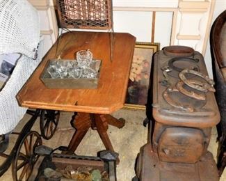 The iron stove on the right is solid; not sure of how many pieces. The horseshoes are authentic. The iron fire-pit is exceptional; I am not sure of the different color stones.