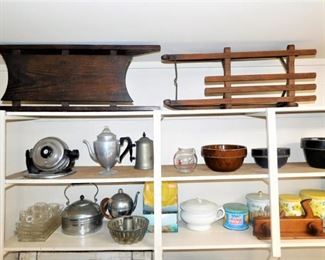 I believe those are infant sleds on the top shelf. Both are antique.