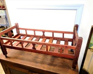 This crib on top is impressive, especially the head & foot; painted red.