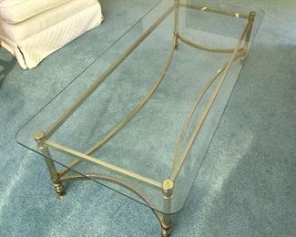 12. Glass and brass coffee table  $65
52” x 24” rounded corners on tempered glass top, no chips or cracks.  Brass legs have minor pitting