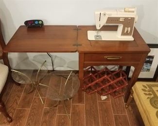 Singer hide a way sewing machine.Two glass & brass side tables.