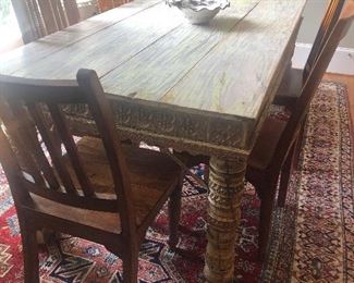Stunning wide-plank ornate farmhouse-style dining room table