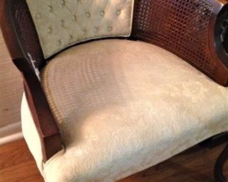 Lovely upholstered chair with cane sides and tufted back