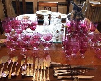 sterling silver and cranberry stems Dining room table with several leaves and drop leaf ends $150.00 and set of 6 dining chairs $250.00