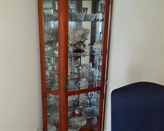 curio cabinet full of glass and crystal