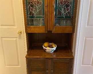 Wood storage cabinet with stained glass panels