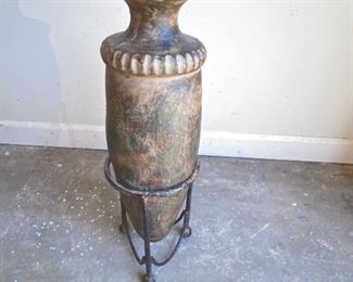 Pottery urn on metal stand