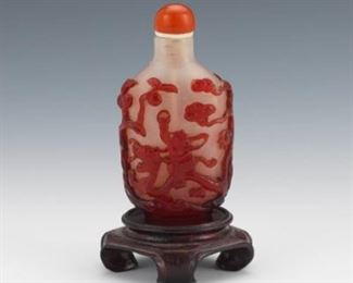 19th Century Qing Dynasty Peking Glass Snuff Bottle with Carnelian Stopper, on Carved Wood Stand 