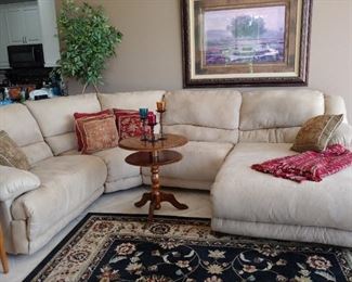 Micro Fiber Couch.  There is another section, not included in this photo, the same size as the corner middle piece against the lounger. Artwork is 45" x 55". Pedestal Table with Chess Board is 24". Rug is 8' x 10'