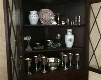 Corner Cupboard with assorted silver plate pieces and Sterling Silver Hollow Ware Wine Goblets.
