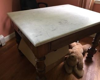 Desk with a marble top.