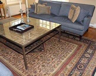 Like new upholstered sofas and custom made coffee table, hand knotted Persian rug