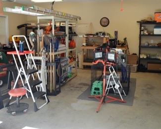 Organized garage full of well maintained tools, shelving, gardening items