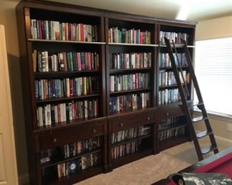 Item:   Thomasville 3 Bookcase Wall Unit with Ladder
Condition:   Good+
Measurements: 40w x 18d x 92h
Description:  3 sections, each section has a top and bottom section, a pull out shelf, and drawer.  

Price:  $2,500

