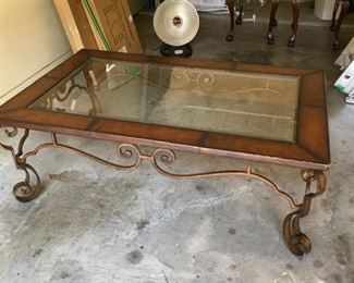 Item:  Iron, glass and wood coffee table
Condition:  good
Measurements:  34w x 54d x 19h
Price:  $125
