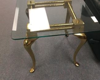. . . one of two matching brass and glass end tables.