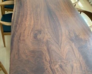 Solid walnut live edge slab dining table with solid cast bronze base legs by Jeffrey Greene. MEASUREMENTS: 31"H x 94 1/2"L x 48 1/2"D. $1850.