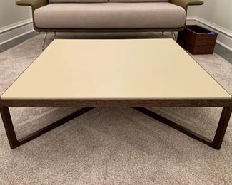 Leather top Knoll coffee table with solid walnut base. MEASUREMENTS: 10"H x 35 1/2" x 35 1/2". $550