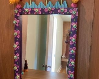 Artisan crafted birds and flowers mirror. MEASUREMENTS: 30"H x 21"W. $75