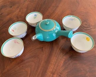 Fine porcelain teapot and cups. MEASUREMENTS: Teapot - 7" wide from handle. Cups 2 1/4"H x 3 1/2"D. $35