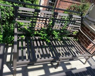 Outdoor love seat - Crate and Barrel - comes with orange cushions and striped pillows. MEASUREMENTS: 33"H x 63"W x 32"D. $475.