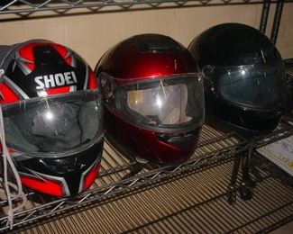 Three older motorcycle helmets