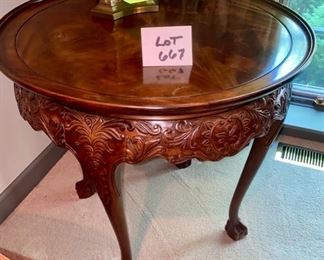 Lot 667. $895.00  This accent table is just jaw-dropping. Round, burlwood carved leg, and surround accent table. This solid wood table with carved ball and claw feet is from the Sherril showroom at the Merchandise Mart.