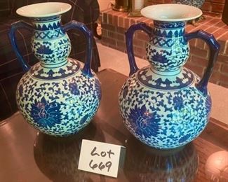 Lot 669.  Pair of blue and white, ceramic double-handled urns. 15" tall, 10" center diameter