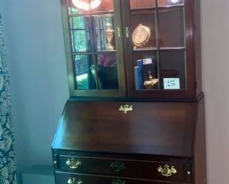 Lot 670A $550.00. Statton Americana Mahogany secretary. Keyed drawers, upper glass door shelves are lighted! Display and functionality! 93" t by 22" base by 38" w.