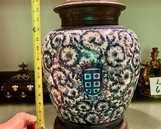 Lot 686. $150.00  Antique Blue & white covered 18.5" Ginger jar. The jar sits in a heavy metal base, jar cover is solid metal too.