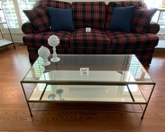 Lot 701. $350.00  Pottery Barn Leona  Rectangular Coffee Table, Antique Brass and Glass.  Like a showcase for collectibles, the glass-topped Leona Coffee table with a mirrored shelf makes a noteworthy display of every item it holds.  Crafted of glass, mirror, and iron.  Top includes tempered glass.  The mirror is backed with MDF.  Antique brass plated frame.  Features one fixed shelf.  $560.00 on sale at PB Now