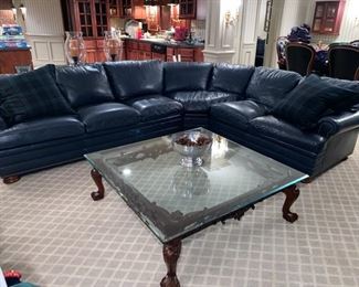 Lot 728  $3,000.00  Royal Blue Leather Hancock & Moore Sectional with Queen Pull-Out Bed and Down Pillowtop. 2  Plaid Floor Pillows are included. The  Cocktail Table Pictured is Lot 729.  $475.00  