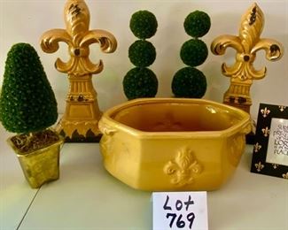 Lot 769.  $55.00.  3 topiary, 1 heavy gold fleur de lis planter, 2 fleur de lis "rustic" statues and frame.  Pot 14"w by 6"  & fleur de lis statues 16in 