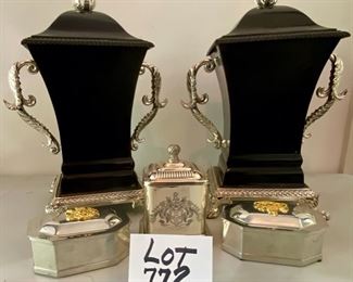 Lot 772.  $75.00. Classy silver and black! Covered silver jar, w/ royal crest, and 2 Steiff Pewter covered dresser boxes, also 2 heavy metal modern urns with lids, 2 handles, and feet.   A steal!